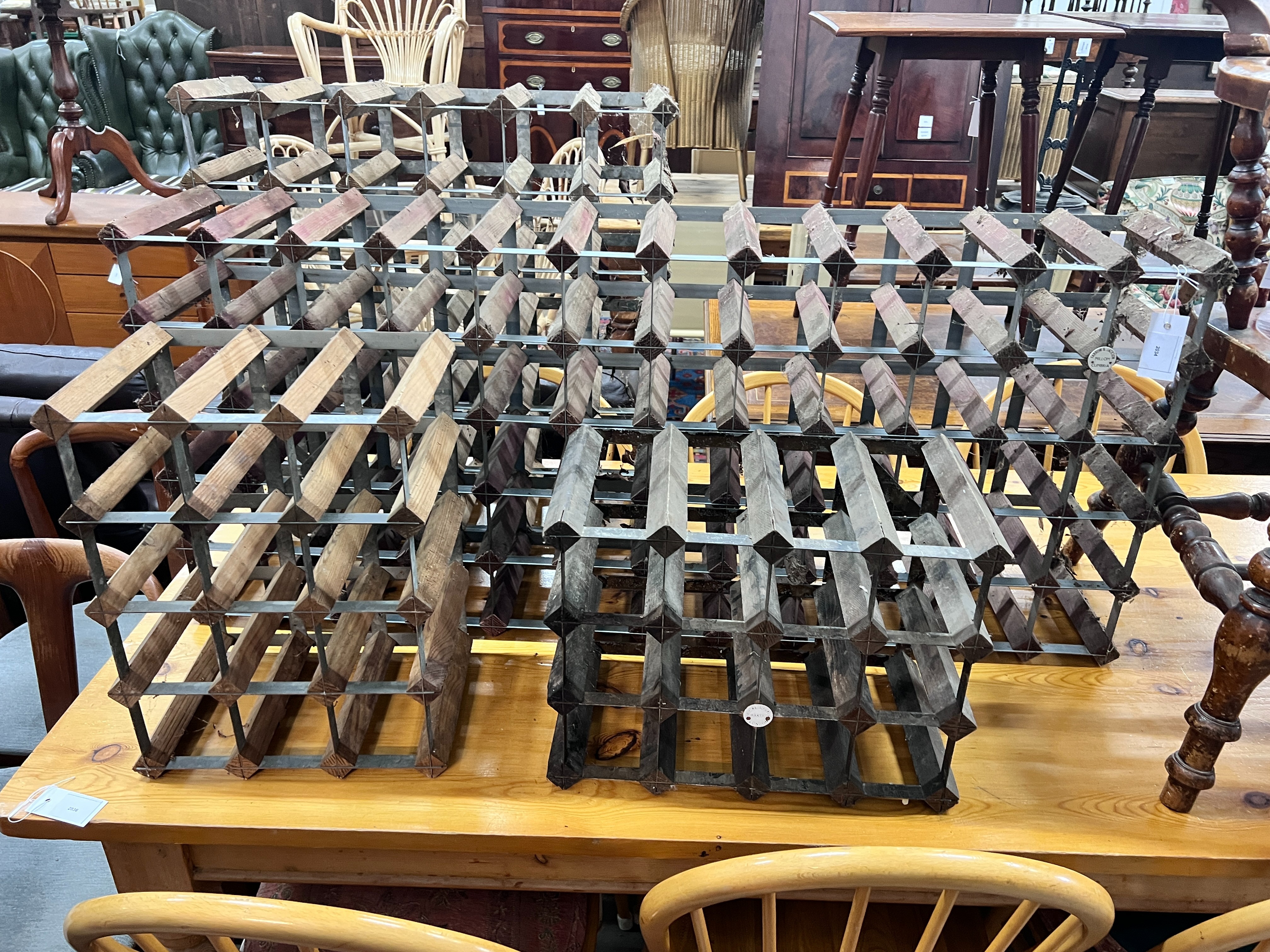 Four vintage wine racks, two labelled Farrow & Jackson Ltd., London and Cumbria, total capacity 120 bottles, largest width 119cm, height 52cm